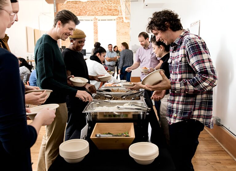 Office team enjoying a buffet-style meal catered by Lish.