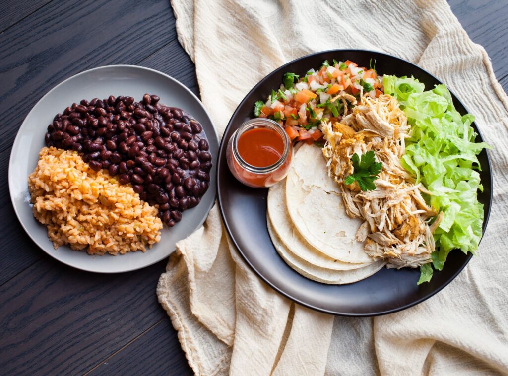 Lish Mexican catering: A build-your-own taco spread with chicken, rice, beans, salsa, and fresh toppings.
