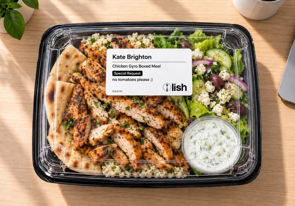 Individually boxed chicken gyro meal from Lish Group Order with a printed label showing the employee's name, meal name and special request